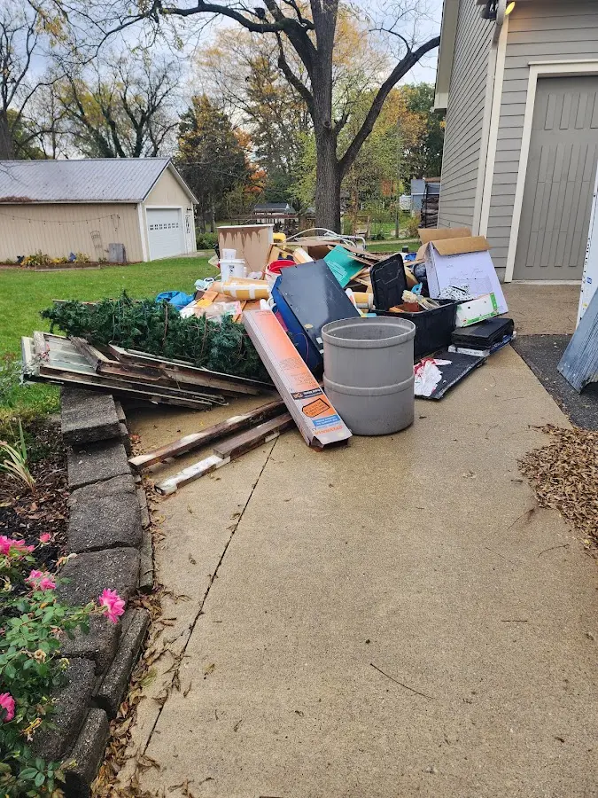 Dumpster being loaded with debris for 10 Yard Dumpster Rental in Southbury